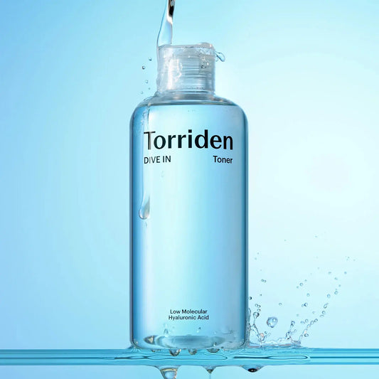Torriden toner bottle with water droplets on a blue background