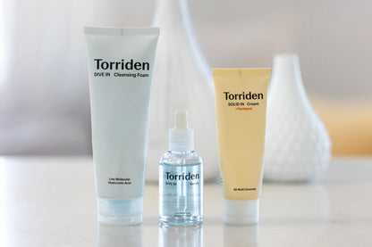 Torriden skincare products including a tube, bottle, and cream on a neutral background